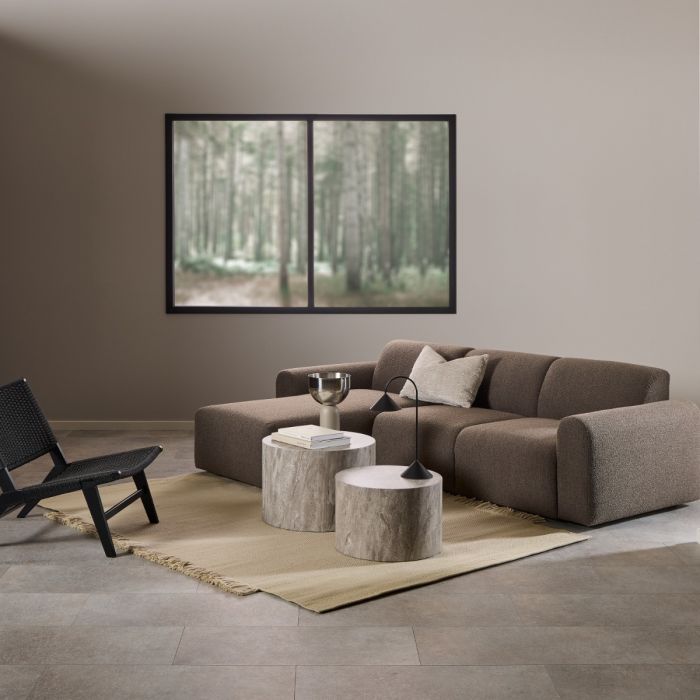 Modern living room with a brown sectional sofa, coffee table, and wall art.