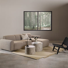 Modern living room with a beige sectional sofa, coffee table, and wall art.