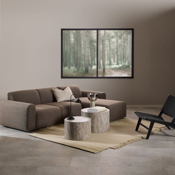 Modern living room with a brown sectional sofa, wooden coffee table, and black armchair.