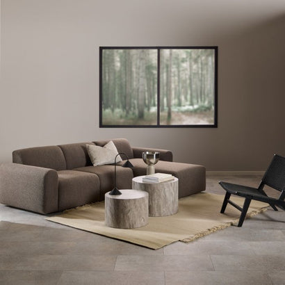 Modern living room with a brown sectional sofa, wooden coffee table, and black armchair.